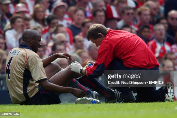 Arsenal's Patrick Vieira gets treatment for a knock on the knee