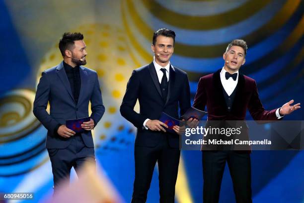 Hosts Timur Miroshnychenko, Oleksandr Skichko and Volodymur Ostapchuk speak on stage during the first semi final of the 62nd Eurovision Song Contest...