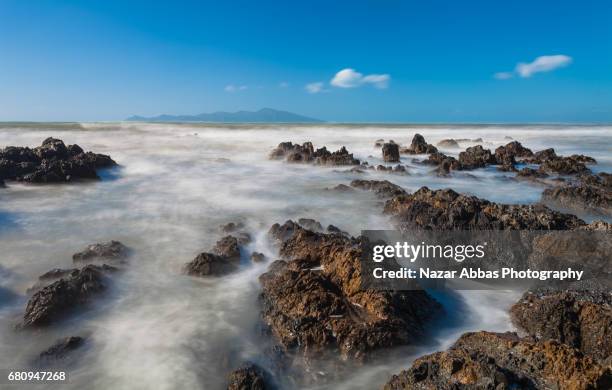 overlooking kapiti island from pukerua bay, wellington, new zealand. - kapiti coast stock pictures, royalty-free photos & images