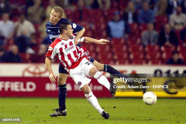 Sheffield United's Dean Windass and Nottingham Forest's Jon Olav Hjelde battle for the ball