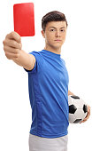 Teenage soccer player showing a red card
