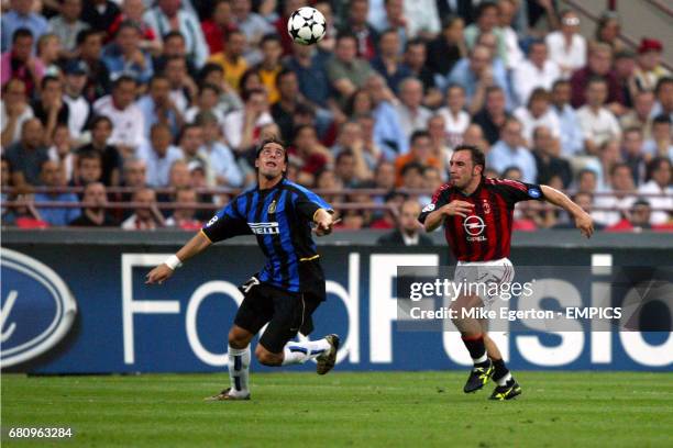 Milan's Cristian Brocchi and Inter Milan's Francesco Coco both run for the ball