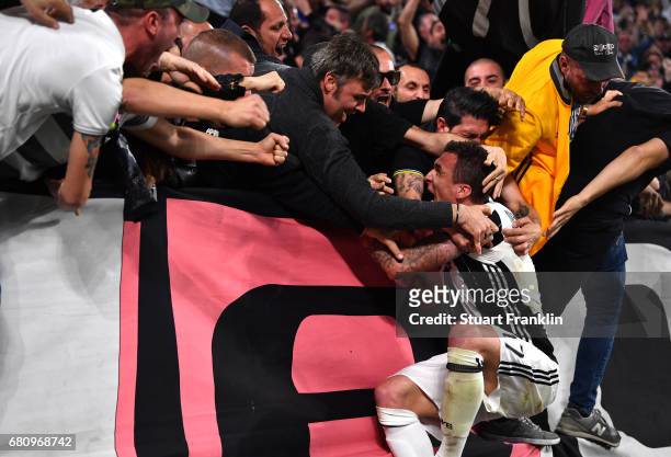 Mario Mandzukic of Juventus celebrates with fans after scoring his sides first goal during the UEFA Champions League Semi Final second leg match...