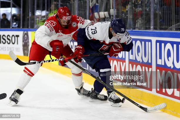 Libor Hudacek of Slovakia challenges Oliver Lauridsen of Denmark for the puck during the 2017 IIHF Ice Hockey World Championship game between Italy...