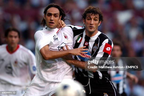 Milan's Alessandro Nesta and Juventus' Ciro Ferrara keep a tight hold of one another