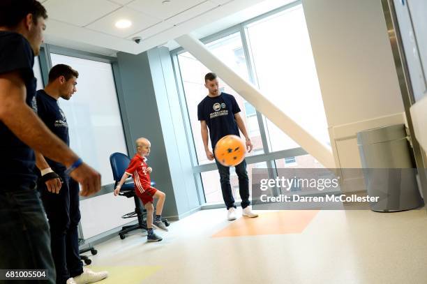 New England Revolution Kelyn Rowe, Joshua Smith, and Matt Turner play hallway soccer with Ewan on May 9, 2017 in Boston, Massachusetts.