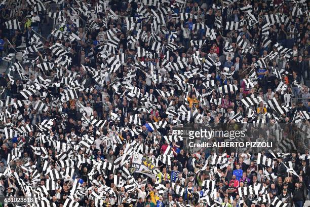 Juventus' fan celebrate at the end of the UEFA Champions League semi final second leg football match Juventus vs Monaco, on May 9, 2017 at the...