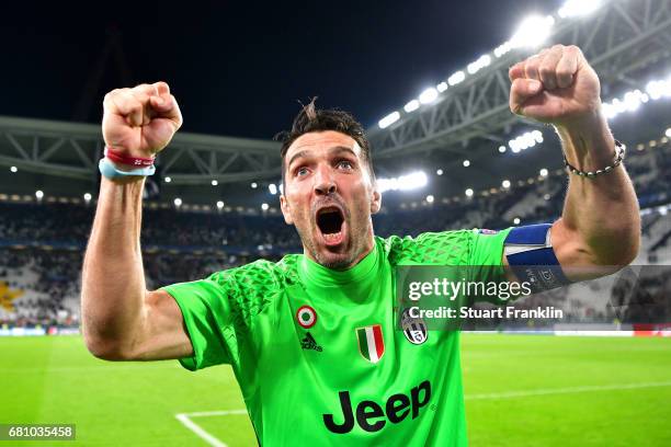 Gianluigi Buffon of Juventus celebrates with fans after the full time whistle following victory in the UEFA Champions League Semi Final second leg...