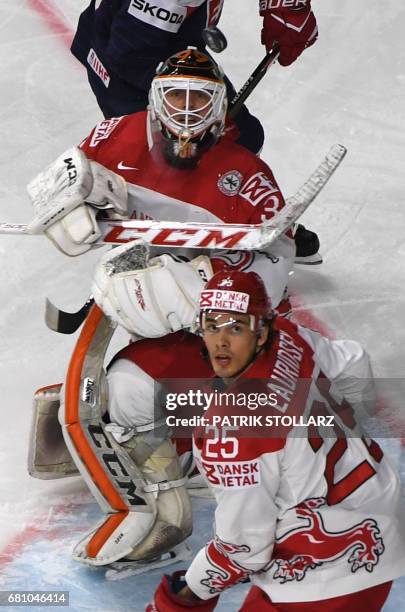 Denmark's Sebastian Dahm and Oliver Lauridsen vie for the puck during the IIHF Ice Hockey World Championships first round match between Slovakia and...