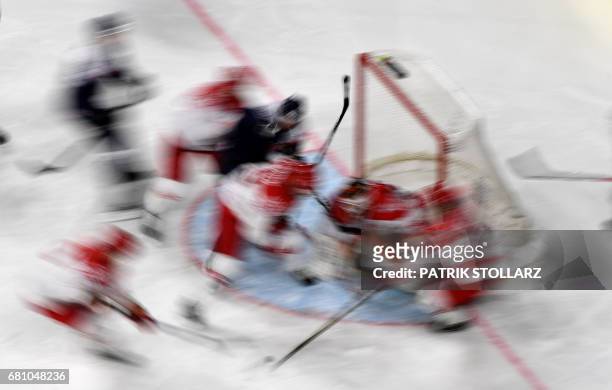 Denmark's and Slovakia's players vie during the IIHF Ice Hockey World Championships first round match between Slovakia and Denmark in Cologne,...