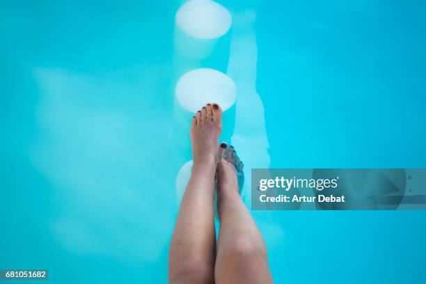 beautiful detail of the legs of a girl resting in a pool with nice blue colors and toenails painted during travel vacations in fuerteventura island. - women with nice legs bildbanksfoton och bilder