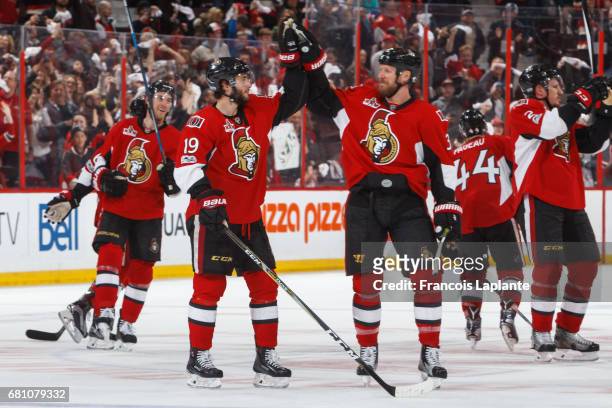 Derick Brassard of the Ottawa Senators and Marc Methot high-five as they celebrate their overtime win against the New York Rangers in Game Five of...