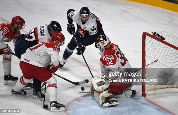 Slovakia´s Marcel Hascak, Denmark's Sebastian Dahm, Nicholas Jensen and Denmark's Mikkel Aargaard vie for the puck during the IIHF Ice Hockey World...