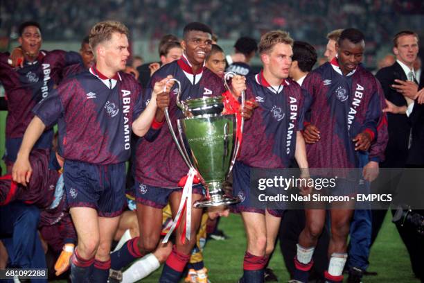 Ajax's Frank de Boer, Nwankwo Kanu, Ronald de Boer and Finidi George celebrate with the European Cup