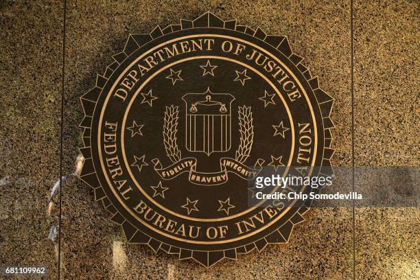 The seal of the Federal Bureau of Investigation hangs on the outside of the bureau's Edgar J. Hoover Building May 9, 2017 in Washington, DC. On the...