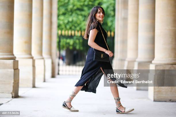Sarah Benziane, fashion blogger Les Colonnes de Sarah, wears an IRL black dress, Zara shoes, and a YSL Saint Laurent bag, on May 6, 2017 in Paris,...