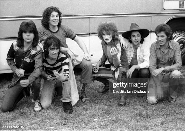 The Sensational Alex Harvey Band, group portrait, backstage at Reading, Festival, Reading, United Kingdom, 25 August 1973. L-R Chris Glen, Alex...