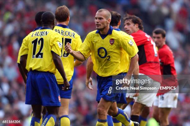 Manchester United's Ruud van Nistelrooy is surrounded at the final whistle by Arsenal's Lauren Ray Parlour and Martin Keown as Fredrik Ljungberg...