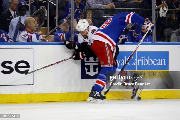 Marc Staal of the New York Rangers checks Chris Neil of the Ottawa Senators during the first period in Game Six of the Eastern Conference Second...