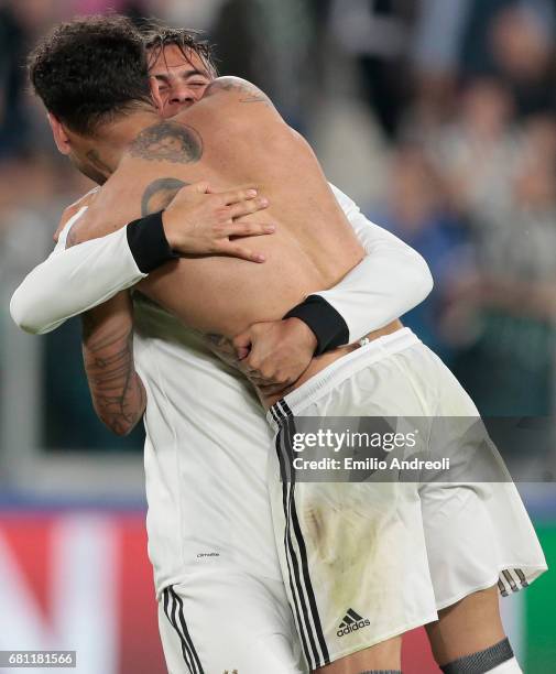 Paulo Dybala of Juventus FC celebrates the victory with his team-mate Daniel Alves da Silva at the end of the UEFA Champions League Semi Final second...