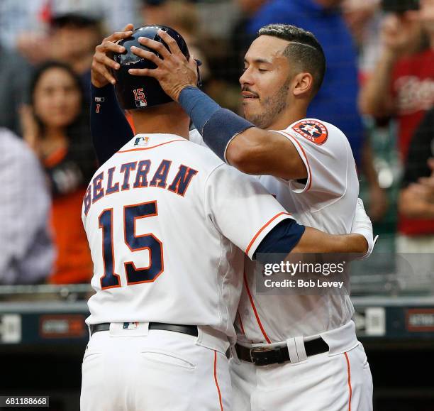 Shortstop Carlos Correa of the Houston Astros congratulates designated hitter Carlos Beltran after his first inning home run against the Atlanta...