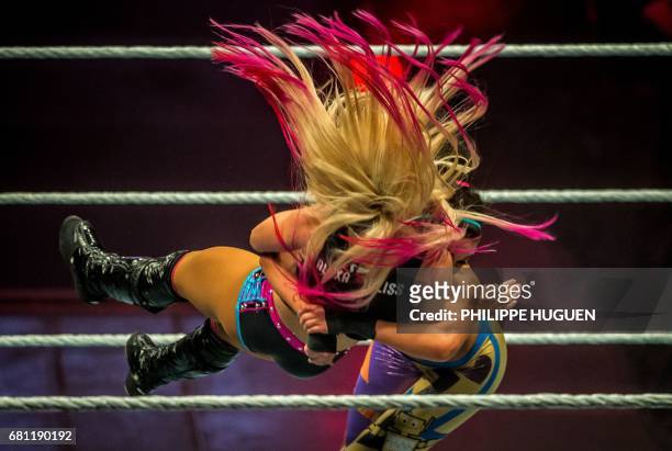 Alexa Bliss and Bayley battle in the ring during the WWE show at Zenith Arena on may 09, 2017 in Lille, France. / AFP PHOTO / PHILIPPE HUGUEN