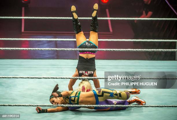 Alexa Bliss and Bayley battle in the ring during the WWE show at Zenith Arena on may 09, 2017 in Lille, France. / AFP PHOTO / PHILIPPE HUGUEN