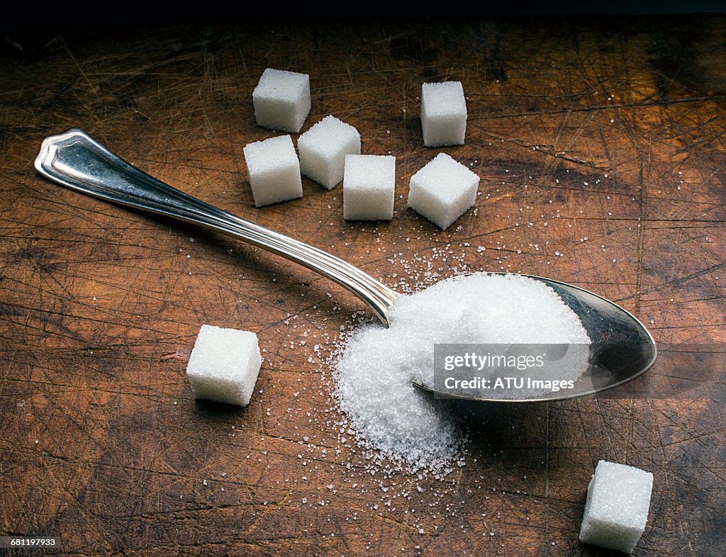 Sugar spoon on wood