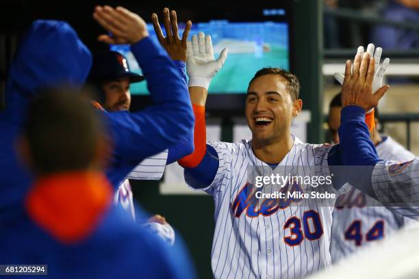 Michael Conforto of the New York Mets celebrates in the dugout after hitting a solo home run in the seventh inning against the San Francisco Giants...