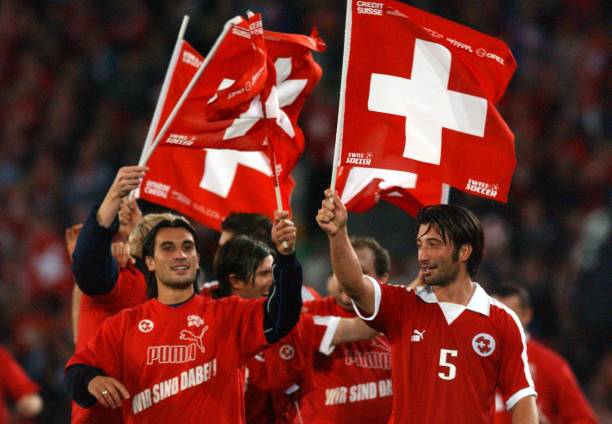 L-r; Switzerland's Hakan and Murat Yakin celebrate their victory and qualification for Euro 2004