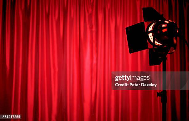 spotlight on red theatre curtains - industria teatrale foto e immagini stock