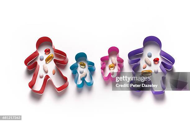 family with dose of vitamins in cookie cutters - dose fotografías e imágenes de stock