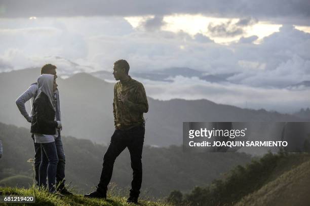 Allan Rushell and his wife Amanda and Helio Neto R), Brazilian players survivors of the air crash in Colombia last November, visit the spot of the...
