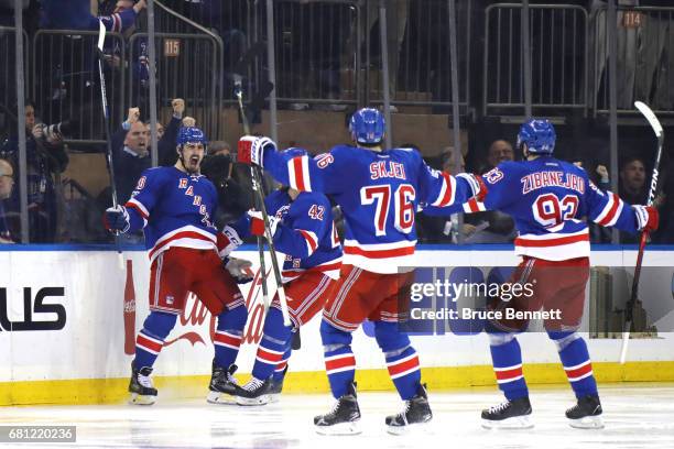 Chris Kreider of the New York Rangers celebrates with his teammates Brendan Smith, Brady Skjei and Mika Zibanejad after scoring a goal against Craig...