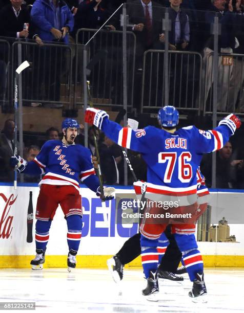 Chris Kreider of the New York Rangers celebrates with his teammates Brendan Smith and Brady Skjei after scoring a goal against Craig Anderson of the...