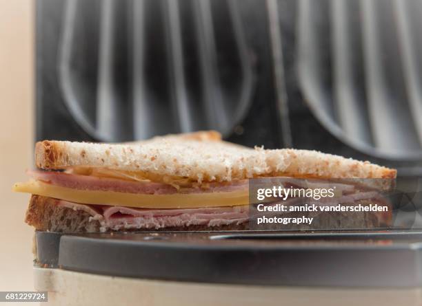 preparing croque monsieur. - cheese toast machine stock pictures, royalty-free photos & images