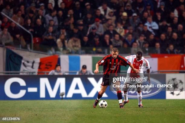 Milan's Andriy Shevchenko shields the ball from Ajax's Abubakari Yakubu