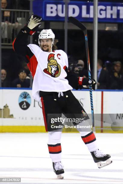 Erik Karlsson of the Ottawa Senators celebrates an empty net goal scored by Jean-Gabriel Pageau against the New York Rangers during the third period...