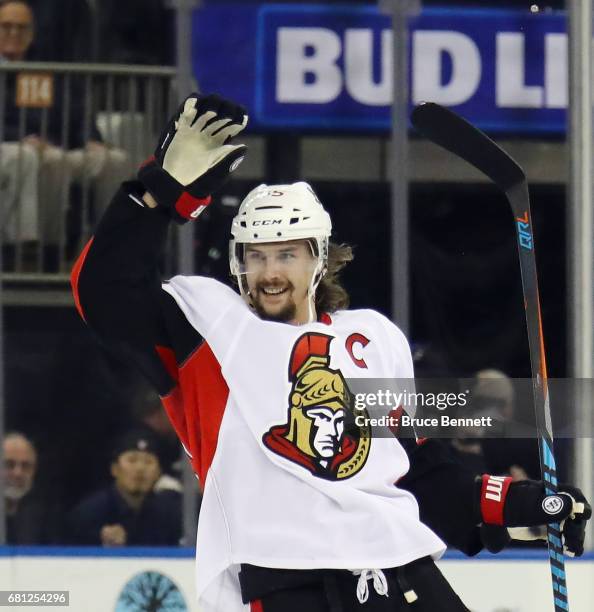 Erik Karlsson of the Ottawa Senators celebrates an empty net goal scored by Jean-Gabriel Pageau against the New York Rangers during the third period...