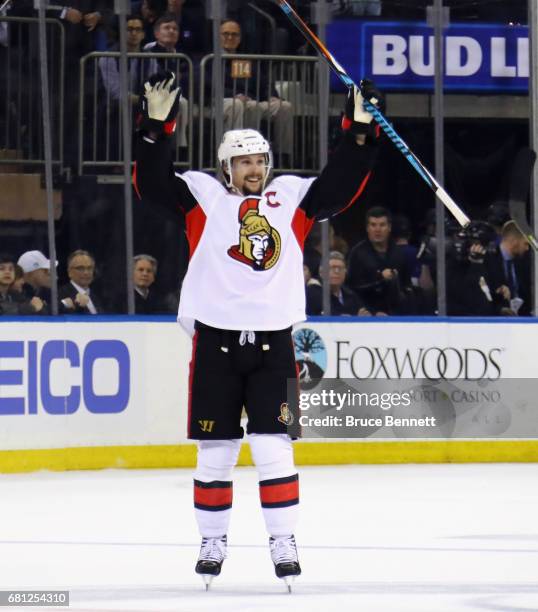Erik Karlsson of the Ottawa Senators celebrates an empty net goal scored by Jean-Gabriel Pageau against the New York Rangers during the third period...