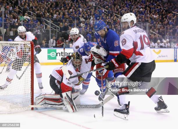 Craig Anderson of the Ottawa Senators makes the save on Rick Nash of the New York Rangers in Game Six of the Eastern Conference Second Round during...