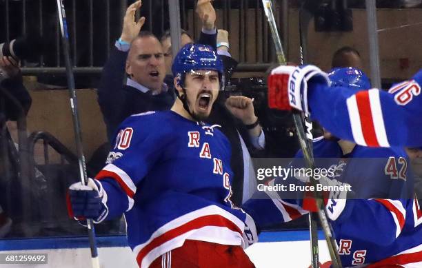 Chris Kreider of the New York Rangers celebrates with his teammates Brendan Smith and Brady Skjei after scoring a goal against Craig Anderson of the...