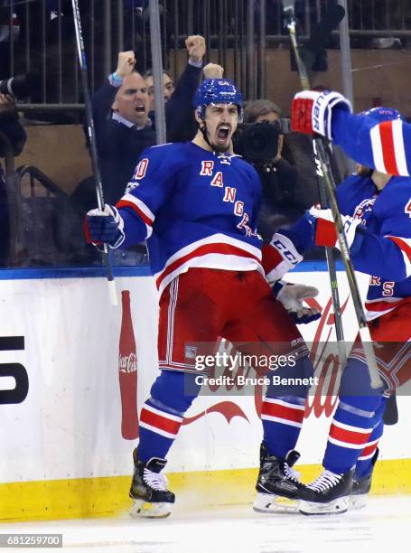 Chris Kreider of the New York Rangers celebrates with his teammates Brendan Smith and Brady Skjei after scoring a goal against Craig Anderson of the...