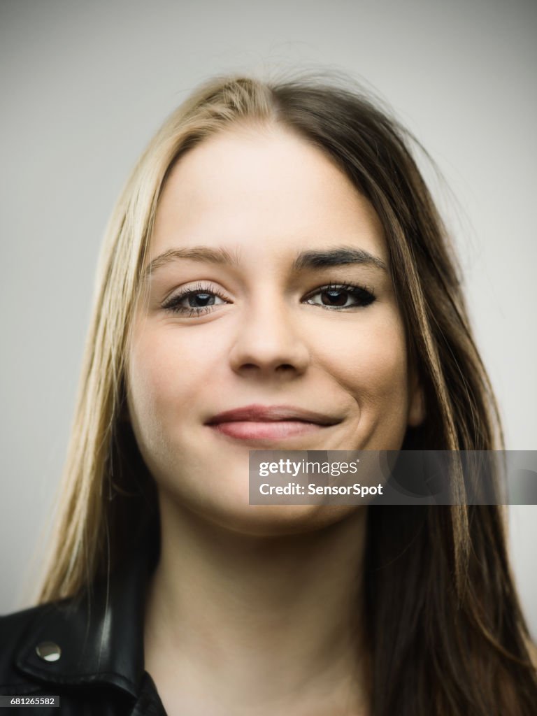 Excited woman smiling against gray background
