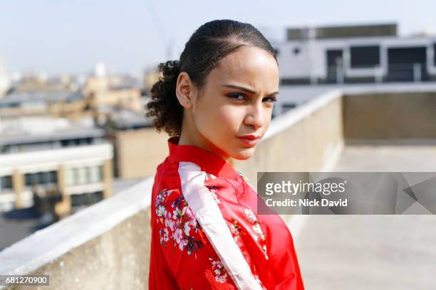 Young street dancer on London rooftop overlooking the city