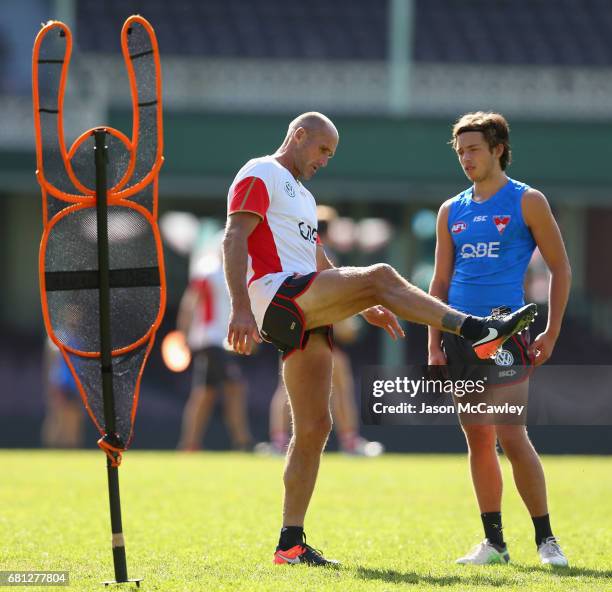 Tony Lockett coaches Oliver Florent of the Swans during a Sydney Swans AFL training session at Sydney Cricket Ground on May 10, 2017 in Sydney,...