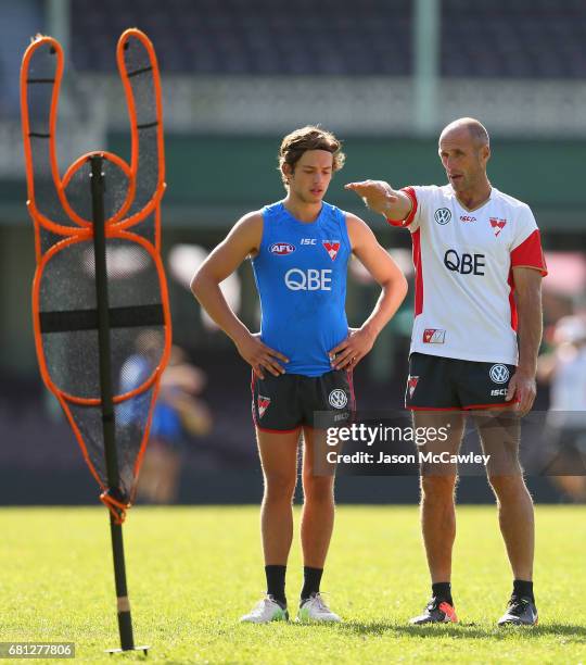 Tony Lockett coaches Oliver Florent of the Swans during a Sydney Swans AFL training session at Sydney Cricket Ground on May 10, 2017 in Sydney,...