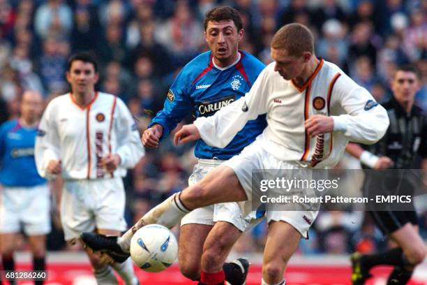 Motherwell's Steven Hammell clears the ball under pressure from Rangers' Shota Arveladze