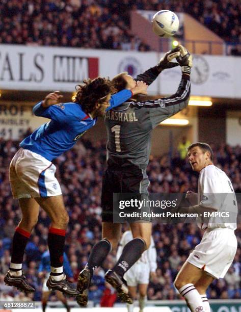 Motherwell's Stephen Craigan watches his goalkeeper Gordon Marshall as he attepts to gather the ball whilst eing challendged by Rangers' Nuno Capucho