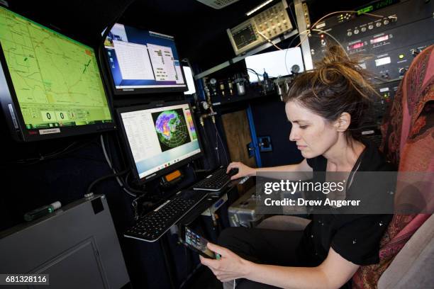 Research meteorologist Karen Kosiba monitors a supercell thunderstorm in the Doppler on Wheels vehicle during a tornado research mission, May 9, 2017...